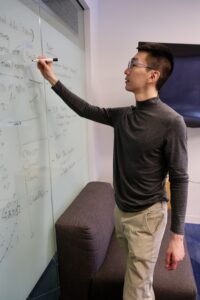 grant ho writing on white board